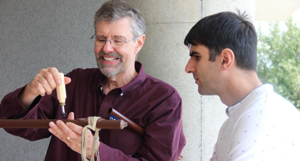 Clint Goss demonstrates the assembly of a Native American Flute to Fab Lab Armenia CEO, Babken Chugaszyan.