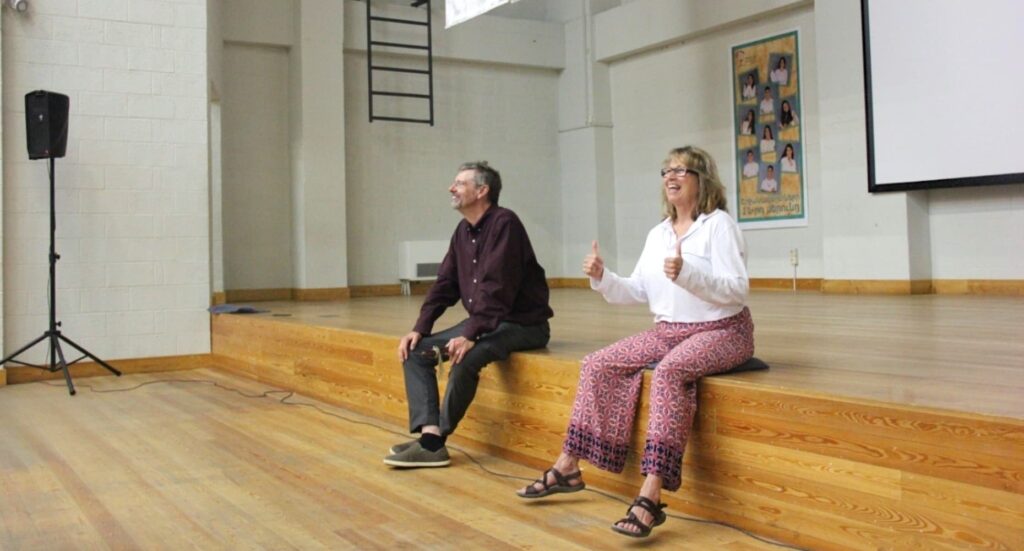 Clint Goss and Vera Shanov facilitating as participants play their Native American Flutes, guiding them through the music-making process.